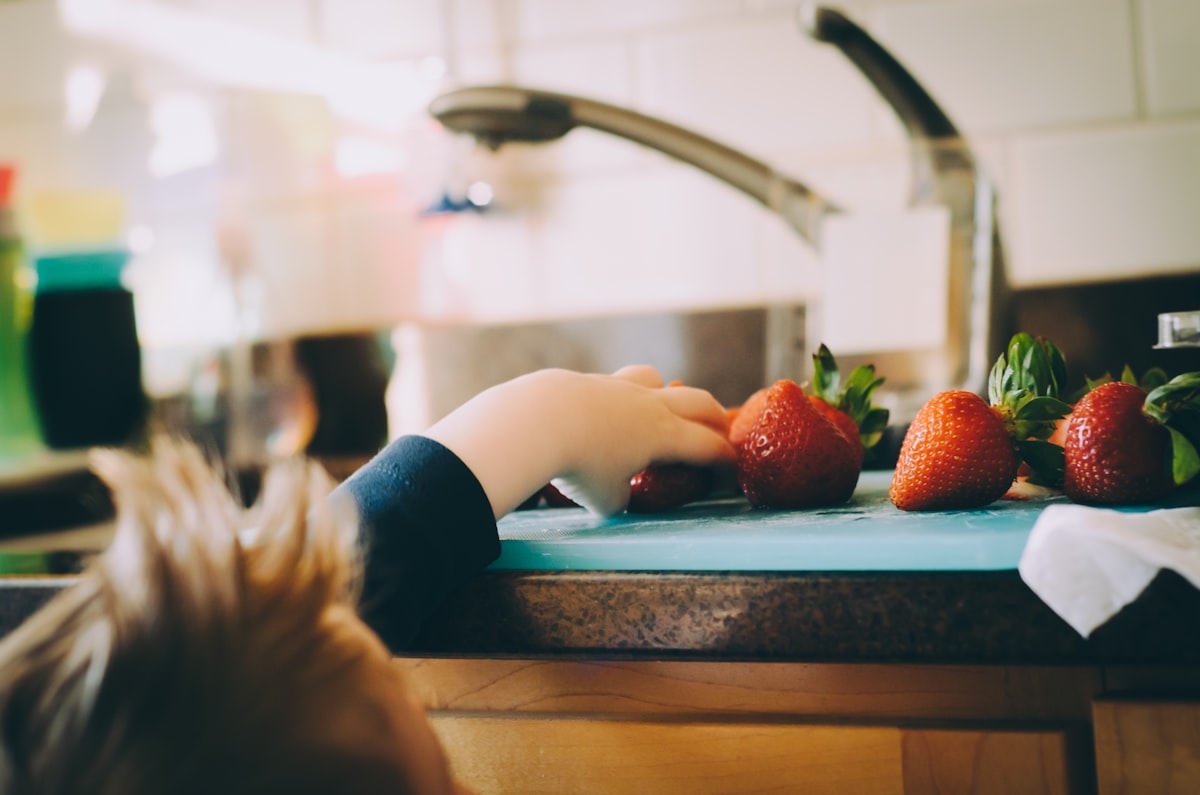 Parent and child preparing vegetables together